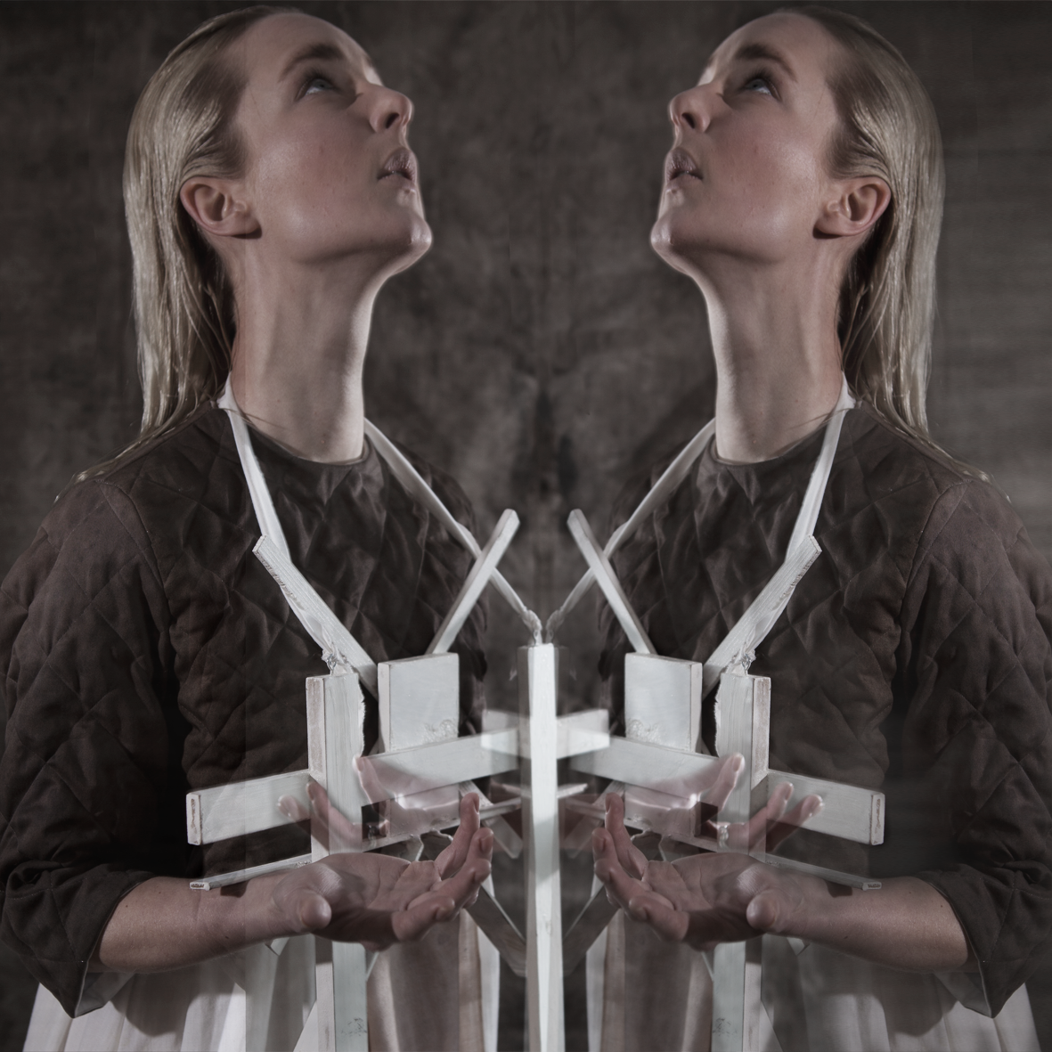 Cross-Bearer — mirrored portrait of two figures bearing cross constructions, gazing upward — Julia Krantz