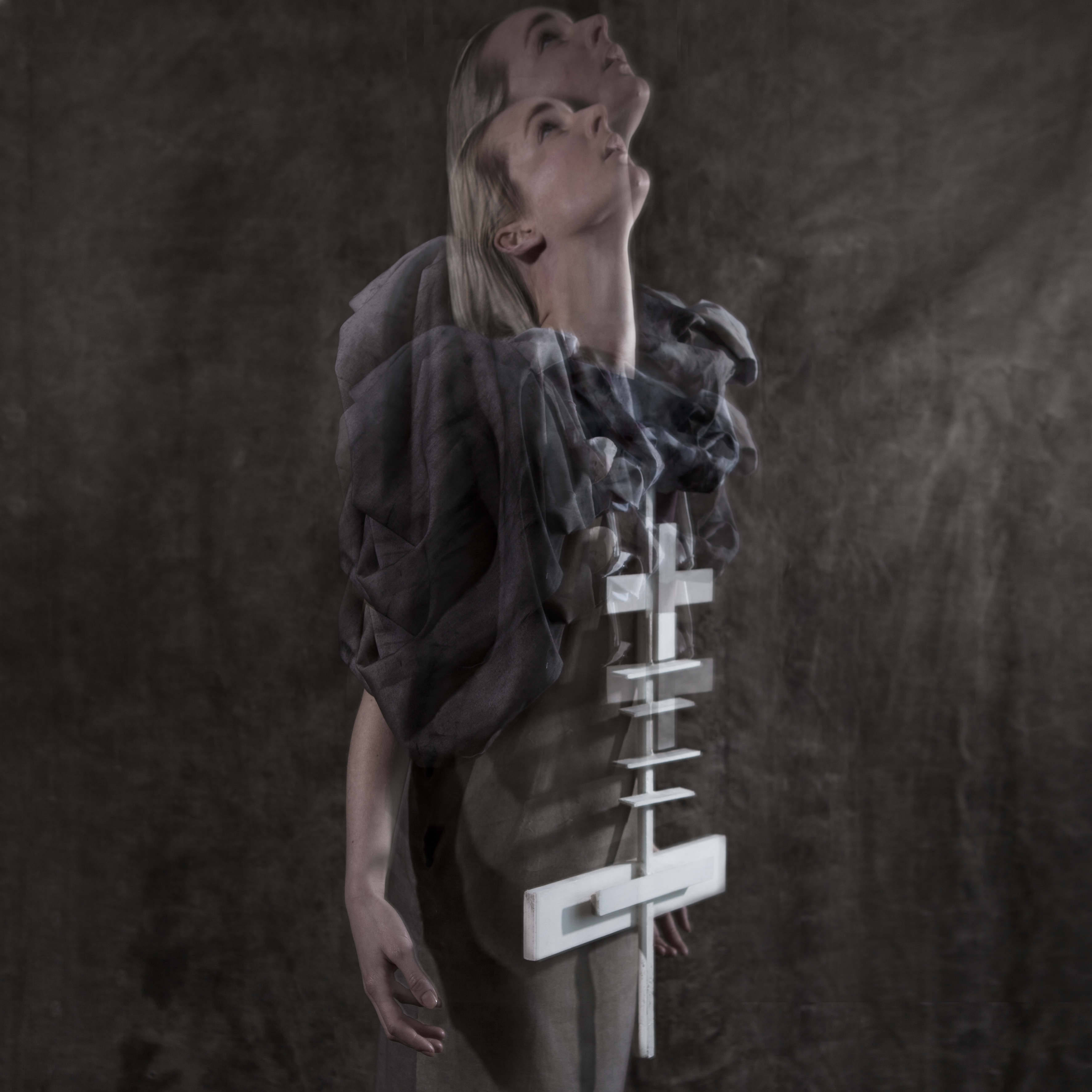 Cross-Bearer — side profile of figure in draped garment with layered cross, head thrown back — Julia Krantz