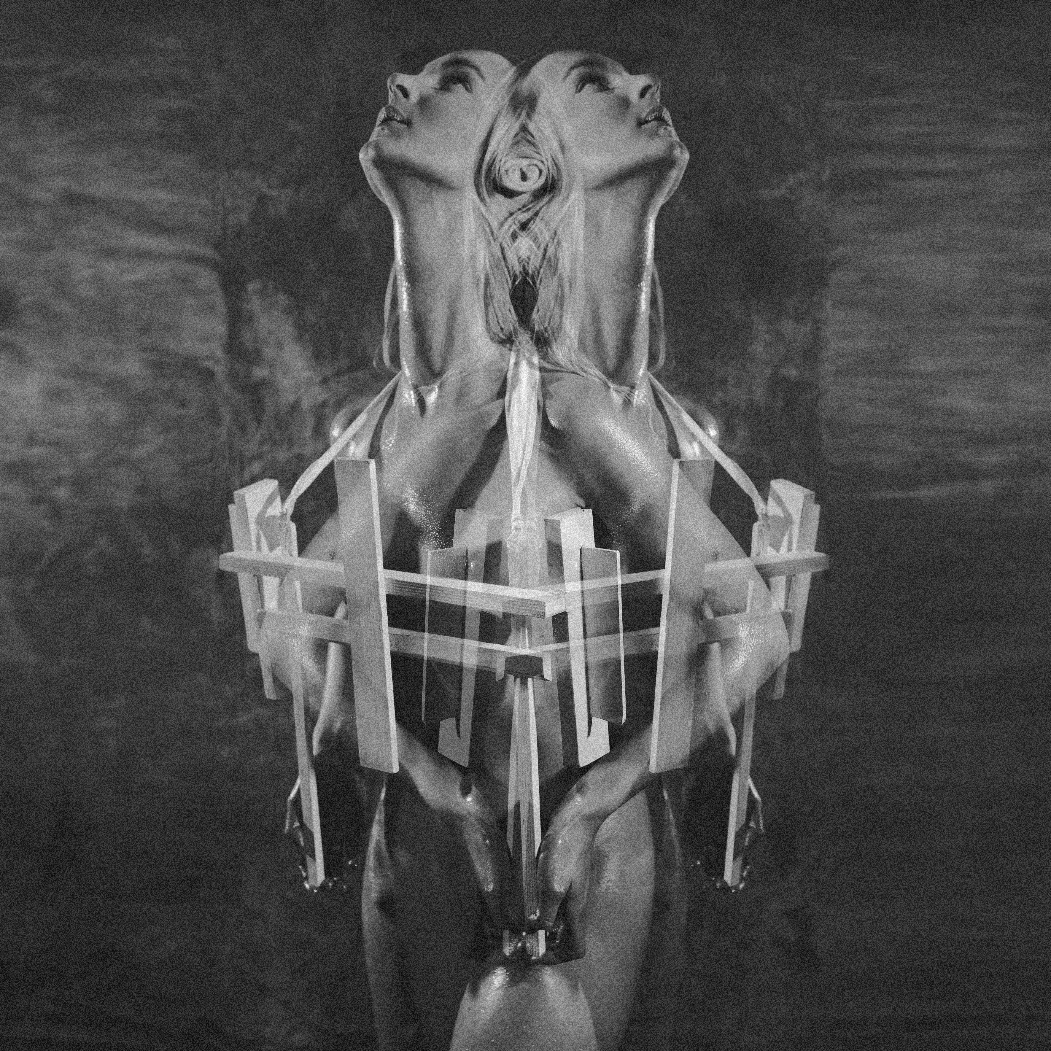Cross-Bearer — black and white overhead mirrored composition with interlocking cross structure — Julia Krantz