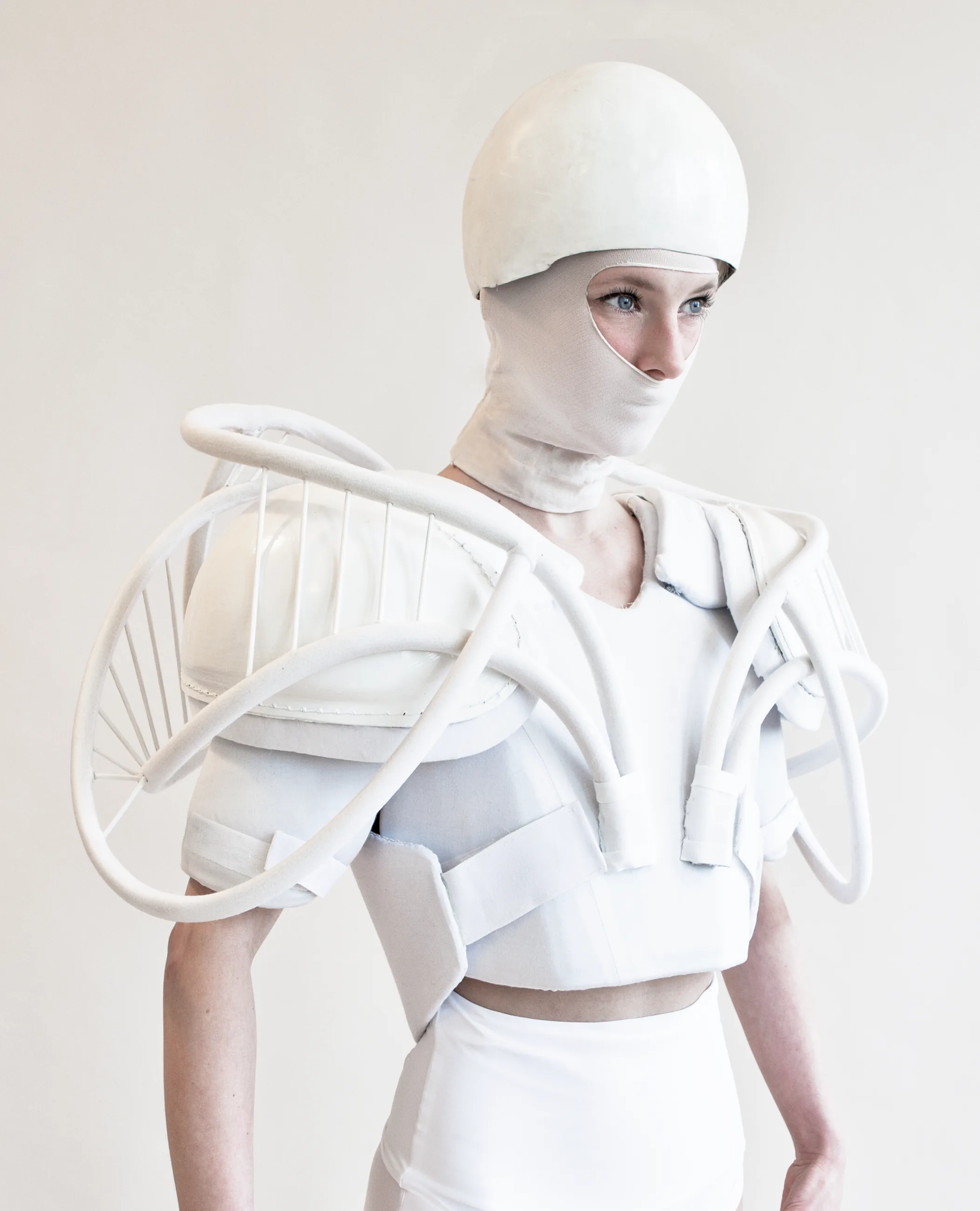White Light — figure in white structured armour costume with helmet and face covering — Julia Krantz